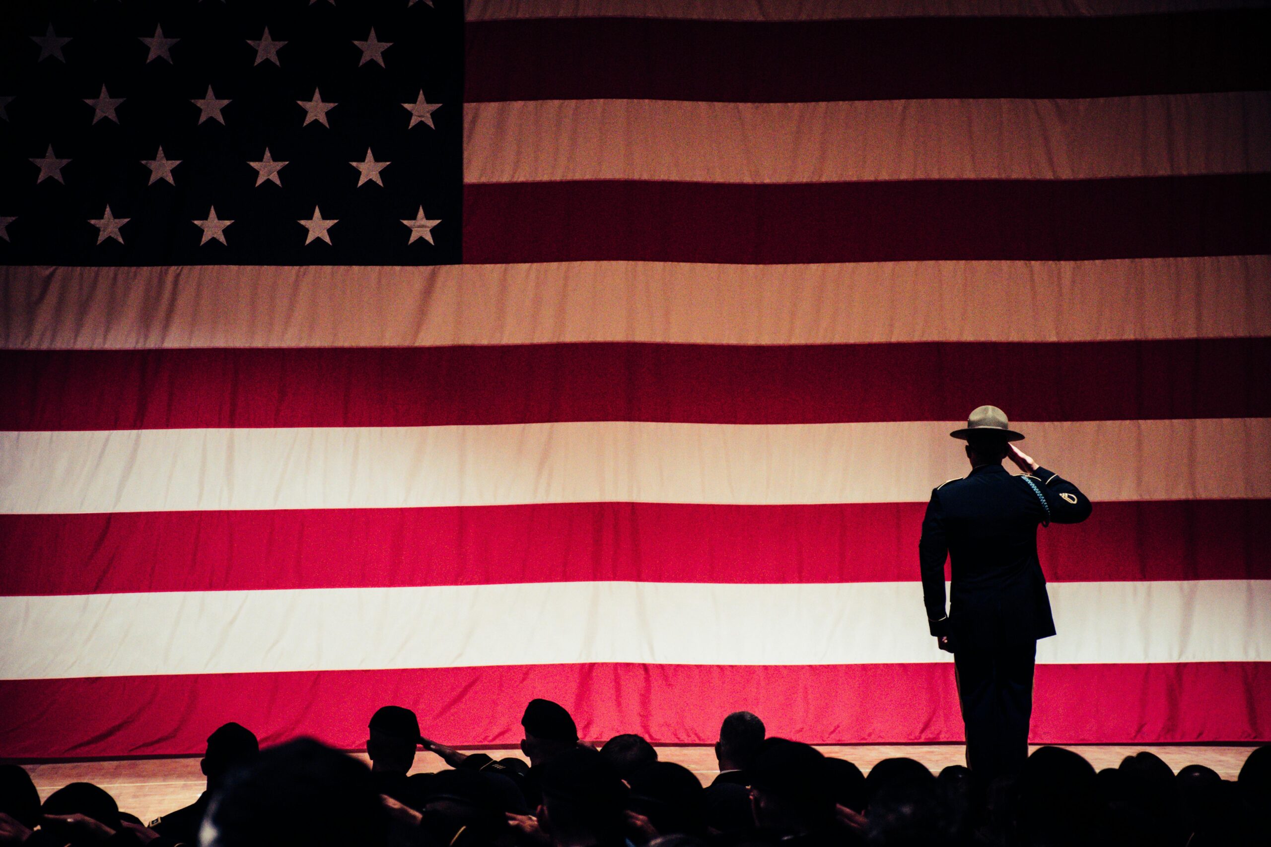 Army veteran saluting in front of crowd